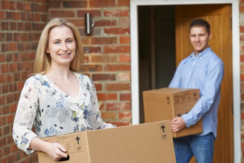 Removal professionals loading commercial items into a van for transport