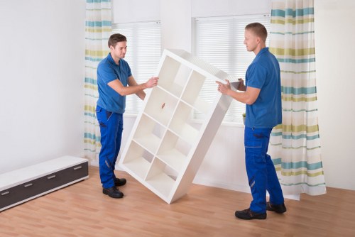 Trained removals staff handling furniture carefully in Fulham